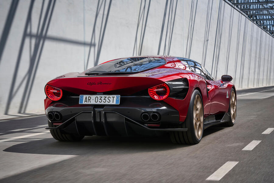 Red Alfa Romeo 33 Stradale with gold wheels â€“ rear quarter driving