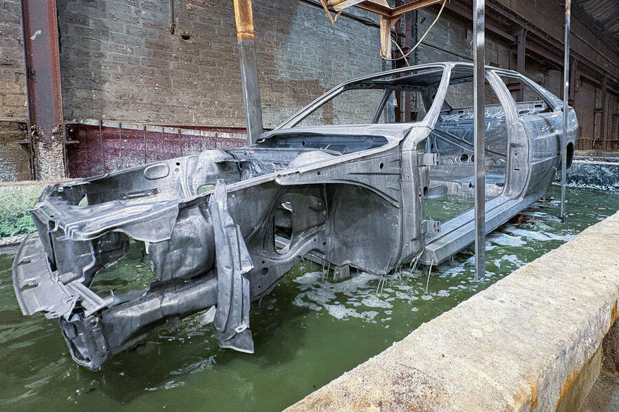 Audi Quattro body in an acid bath for rust removal
