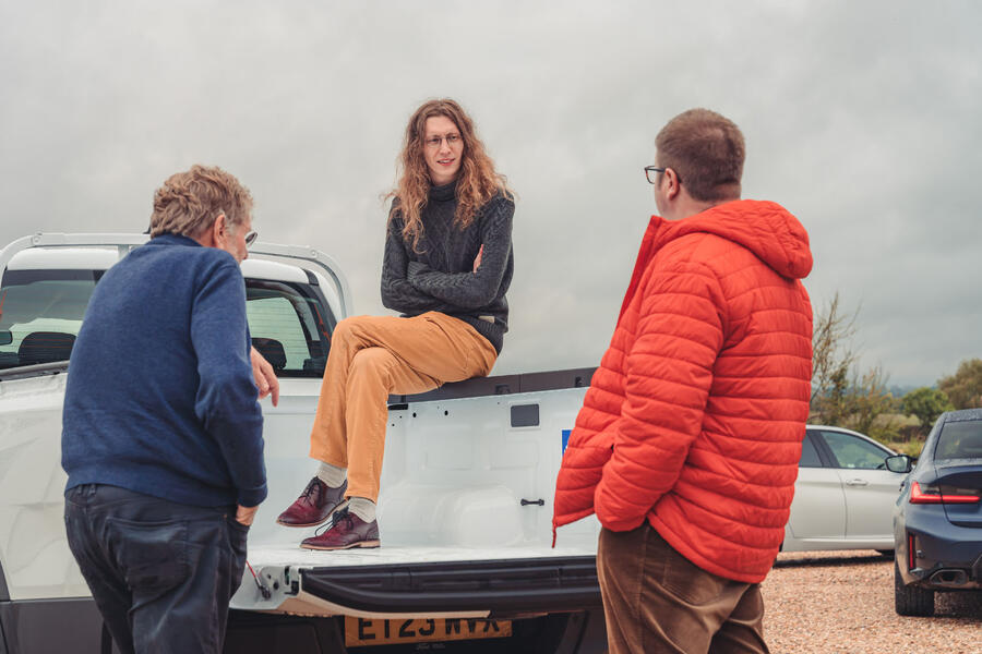 Illya Verpraet sat on Ford Ranger tailgate, talking to Steve Cropley and Matt Saunders