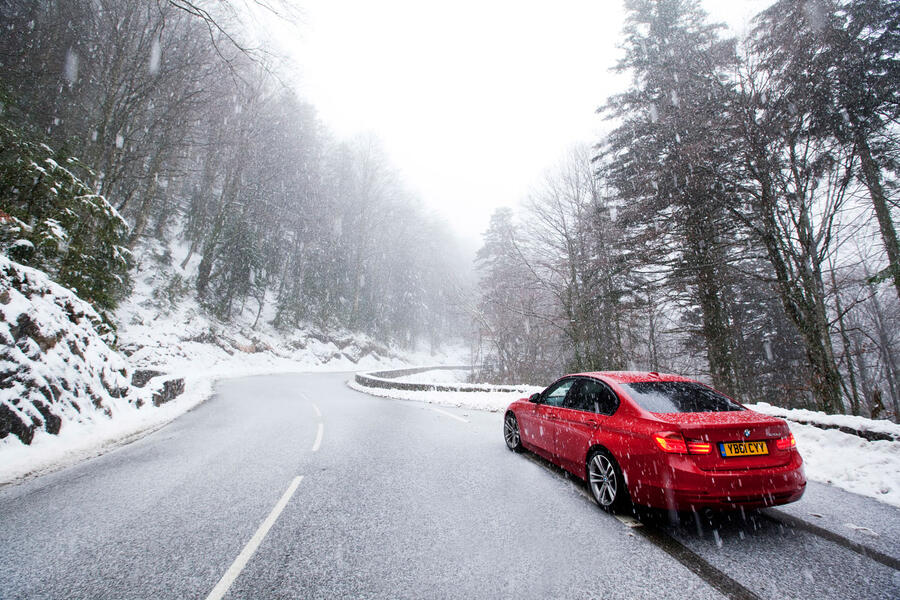 BMW 3 Series stopped on oncoming side of snowy road