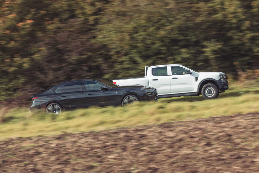 BMW i7 passing Ford Ranger
