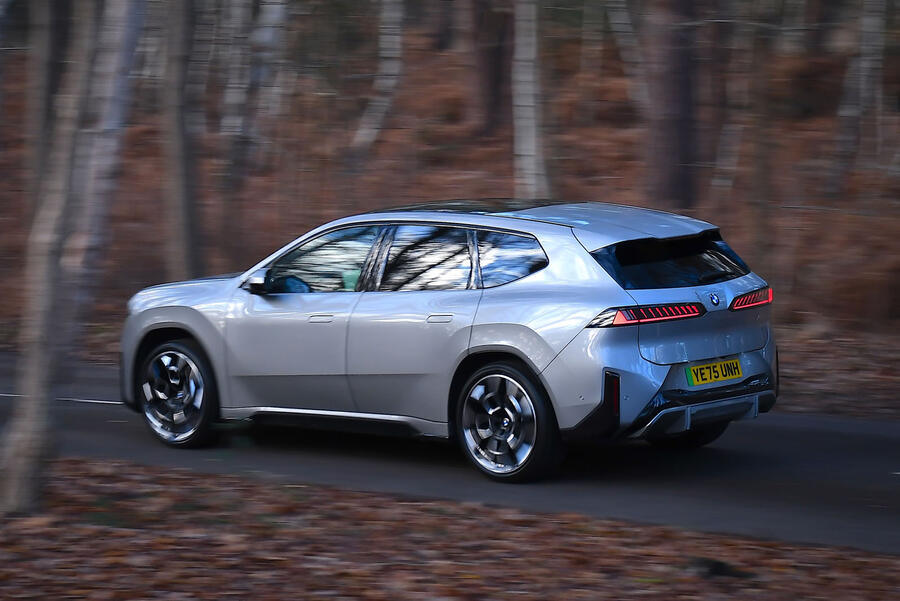 BMW iX3 driving through a forest â€“ rear