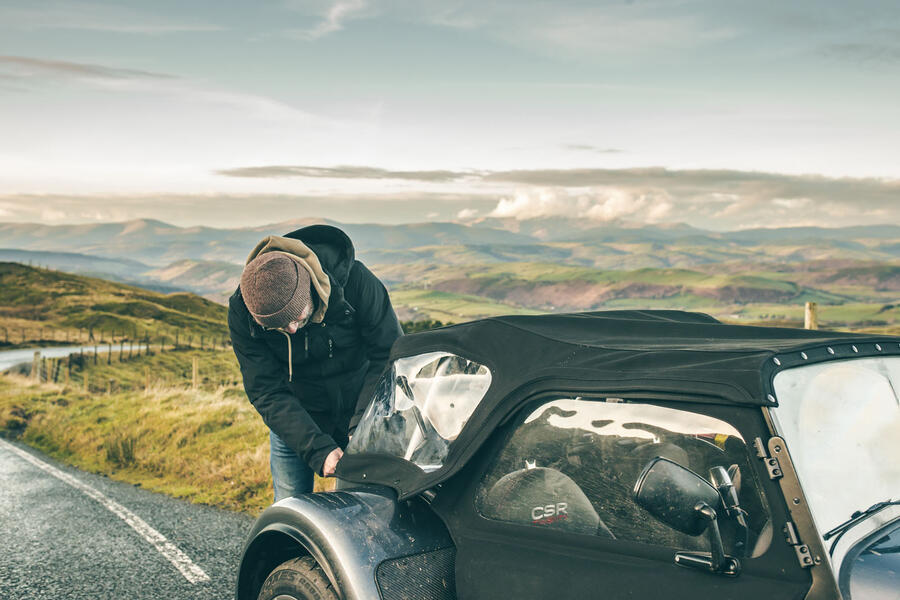 Matt Prior putting a Caterham CSR's roof on