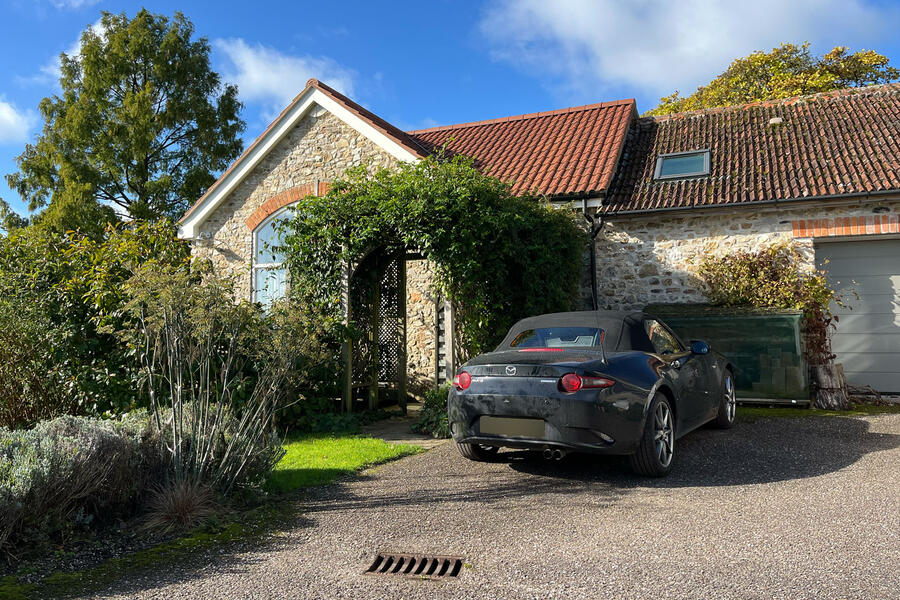 Charlie Martin's Mazda MX-5 parked outside an Airbnb