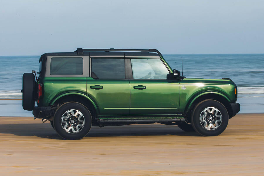 Ford Bronco Badlands driving along beach – side