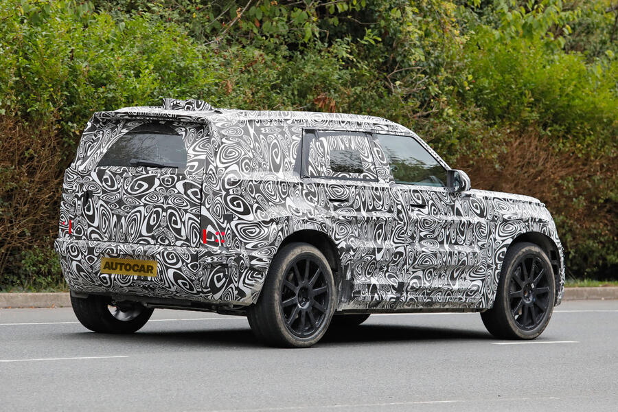 Defender 'Sport' driving on road in camo
