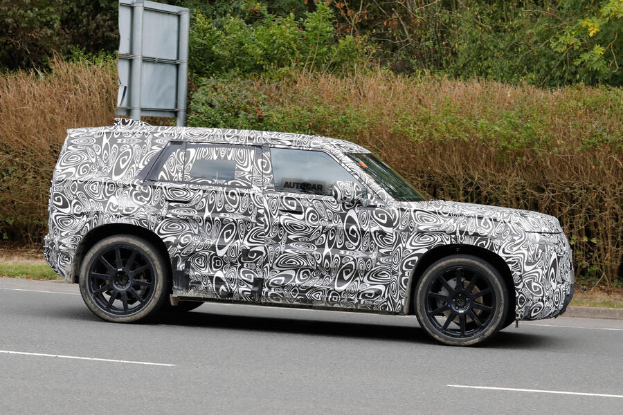 Defender 'Sport' driving on road in camo