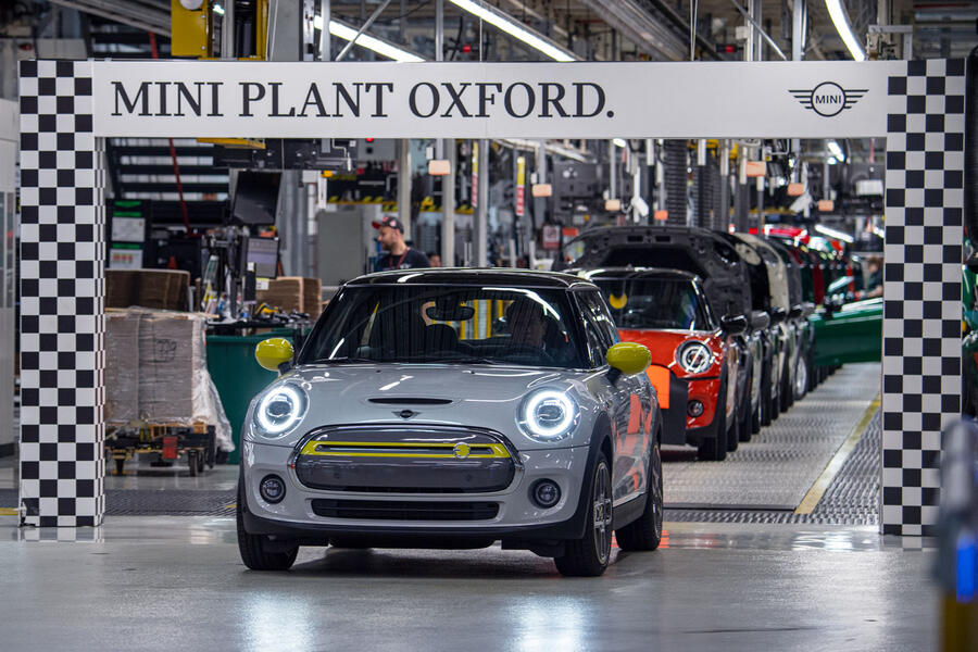 A Mini Cooper SE drives off the production line at the brand's Oxford, England factory, viewed from the front