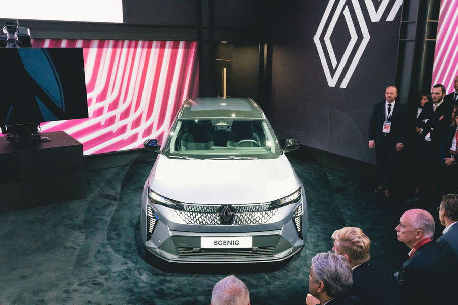 2024 Renault Scenic unveiling at Munich motor show. A crowd looks at a grey car.