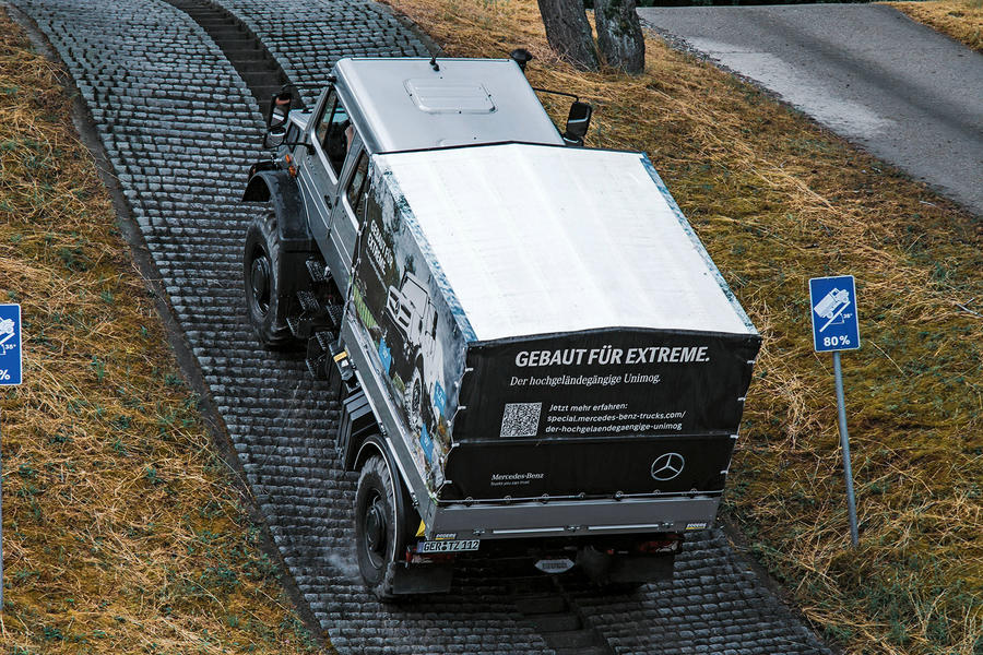 Unimog climbs an 80 percent grade hill with cobbled surface – rear quarter