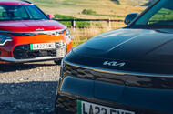 black kia niro in front of red kia niro black kia niro in front of red kia niro