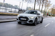 Grey Audi A1 driving down a city street