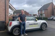 Mini E owner lead Mike Nunn teaches pupils in a Mini E, having first bought a Renault Zoe