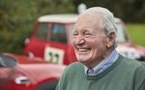 Paddy Hopkirk with Minis in background