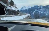 The perfect view: the long bonnet of the Toyota GR Supra and a twisty Alpine road with a dramatic backdrop