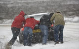 Pushing car stuck in snow