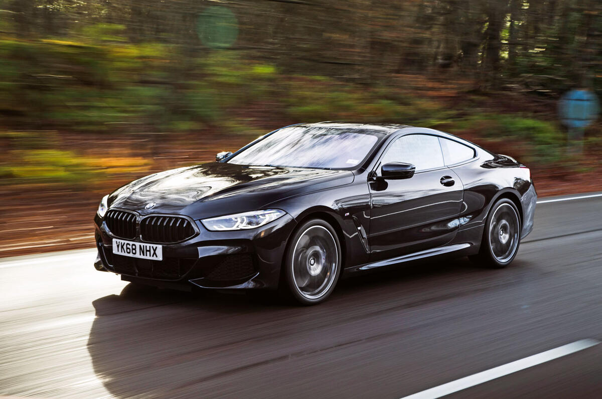 BMW 8 Series Coupe in profile, showcasing its long hood and sweeping roofline