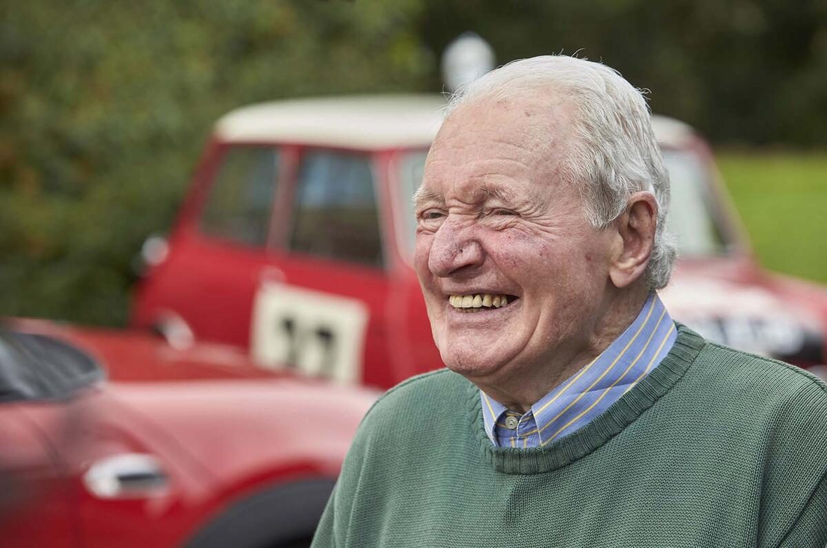 Paddy Hopkirk with Minis in background
