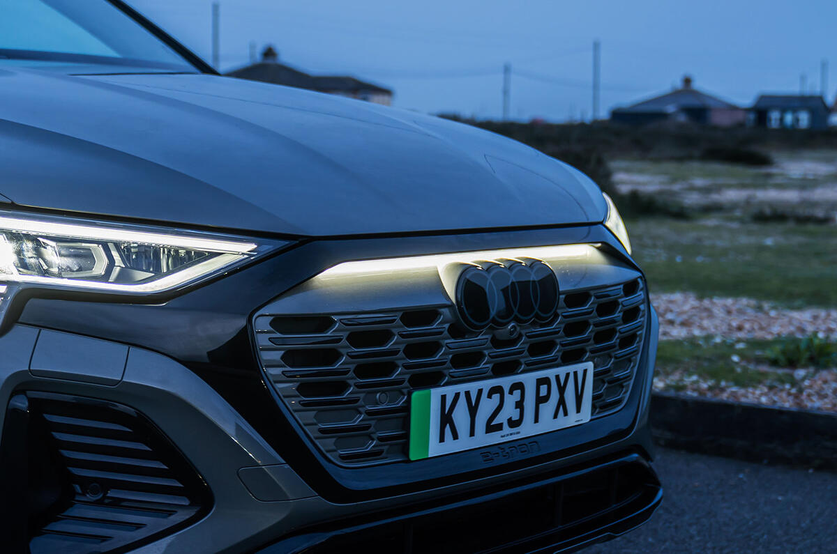 The Audi Q8 e-tron's exterior ambient lighting with grille illumination in action