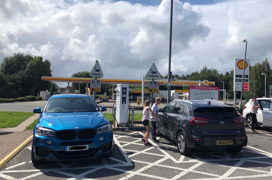 The Kia e-Niro meets a (diesel) BMW X6 in an electric charging bay