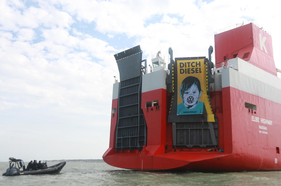 Greenpeace protesters hang banner from ship
