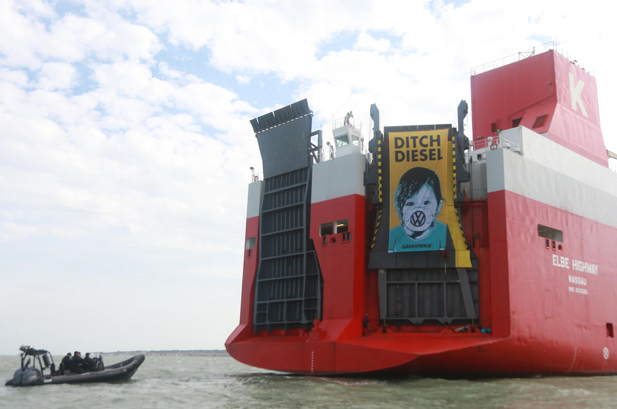 Greenpeace protesters hang banner from ship