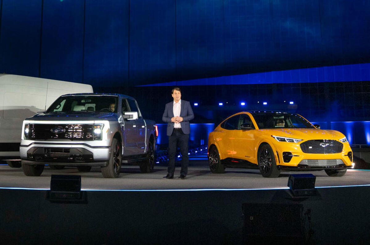 jim farley with ford f 150 lightning and ford mustang mach e