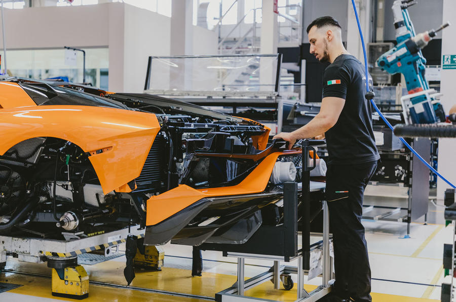 McLaren factory worker installing bumper