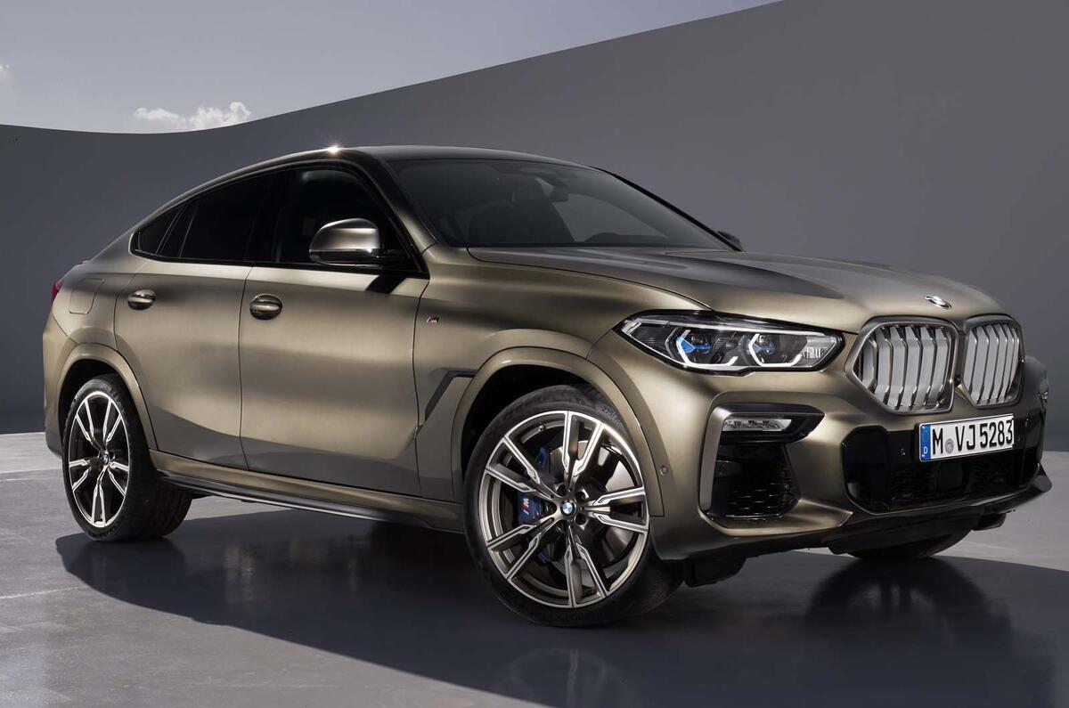 Rear view of silver BMW X6 with fog lights on parked on a tarmac