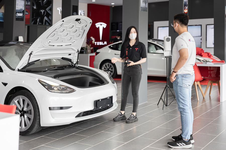 Tesla Model 3 in showroom buying face to face